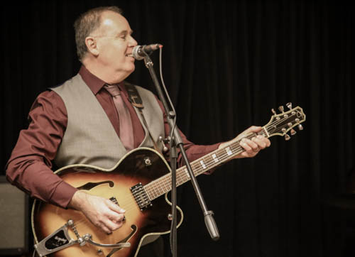 Paul of 2BEATZ singing and playing guitar